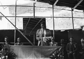 Official opening of the new village.  The D.O. Tsuen Wan, Mr. S.A. Webb-Johnson speaking (23 April 1964) - Heung Yee Kuk Chairman Mr. HO Chuen Yiu, - District Commissioner N.T., Mr. J.P. Aserappa. (Image)