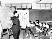 A police officer lecturing to children on road safety, 1961