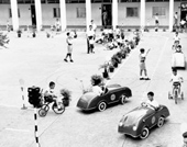 Children learning traffic rules and regulations at school, 1962