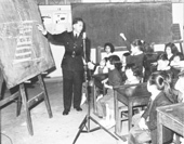 A police officer lecturing school children on road safety, 1962