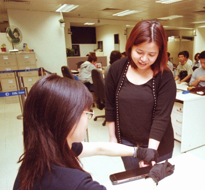 Thumbprint taking for an ID card applicant. (c.2000)